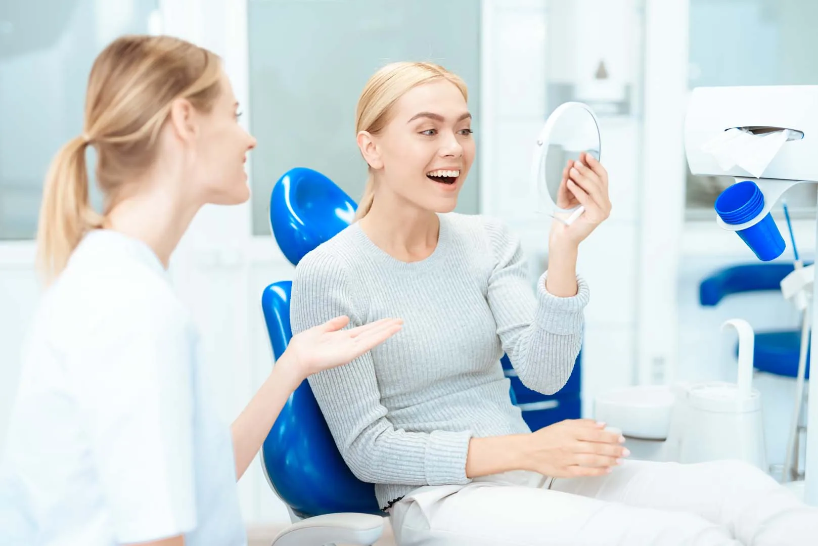 Patient looking in mirror during Snap-On Smile consultation at Kayscreek Dental